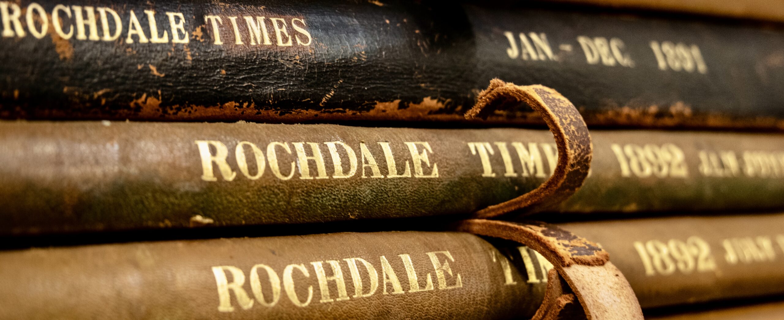 Close up of antique bound copies of Rochdale News