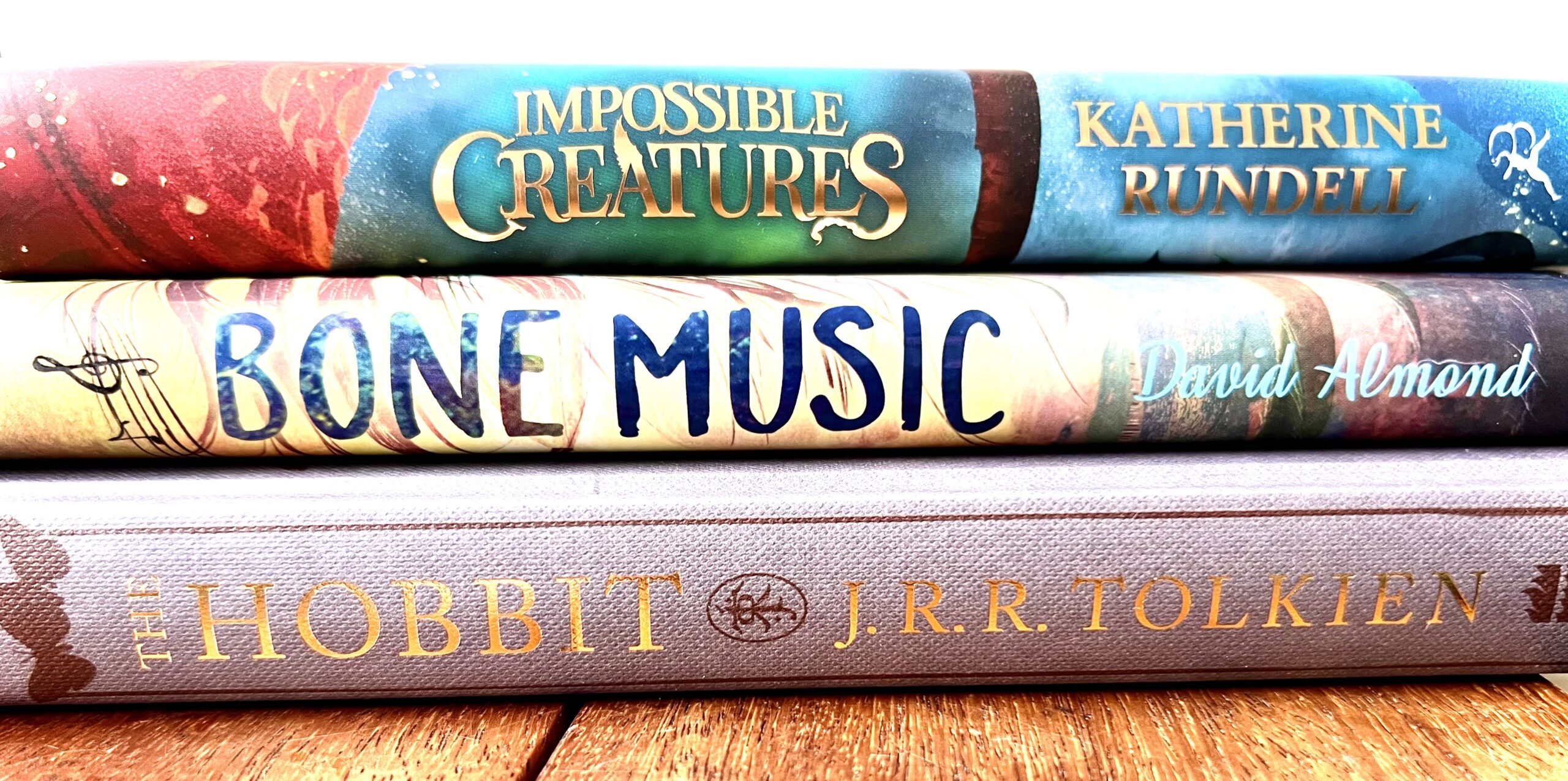 A photo of the spines of 3 books, Impossible creatures, Bone Music and The Hobbit