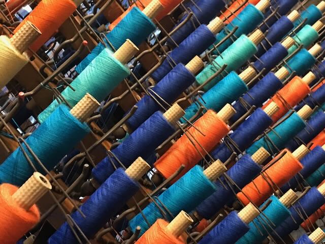 Photo of reels of thread on a loom